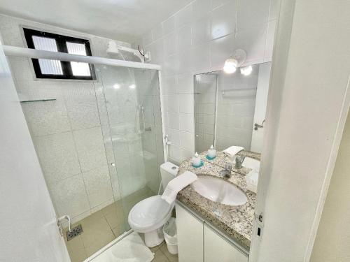 a bathroom with a toilet and a sink and a shower at Alessandra Residence | Meireles - CE in Fortaleza