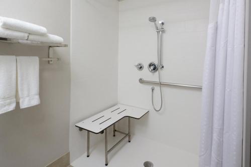 a white bathroom with a shower and a table at Holiday Inn Express & Suites Raleigh Durham Airport at RTP by IHG in Durham