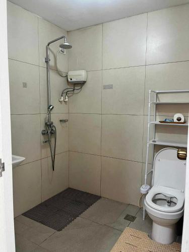 a bathroom with a shower and a toilet at Arabella Transient Home in Baguio