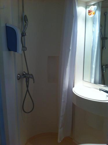 a bathroom with a shower and a sink at Premiere Classe Cergy Saint Christophe in Cergy