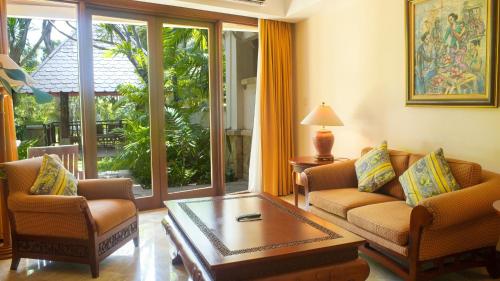 a living room with two chairs and a coffee table at Lorin Solo Hotel in Solo