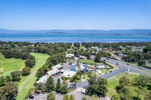 an aerial view of a town with a lake at Golf Place Inn Wollongong in Wollongong