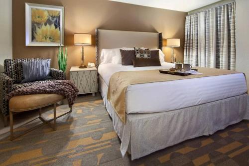 sypialnia z dużym łóżkiem i krzesłem w obiekcie Weekends in May and June - Amazing Deluxe 1-Bedroom - Next to Sphere in Las Vegas! w Las Vegas