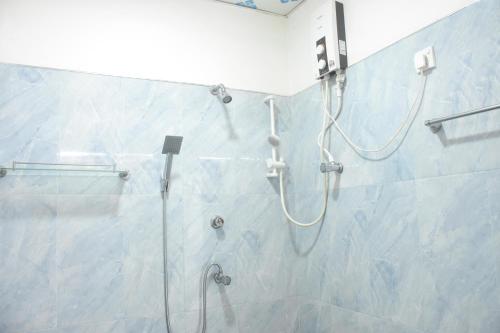 a shower in a bathroom with a glass shower stall at Royal Inside Hotel in Udawalawe