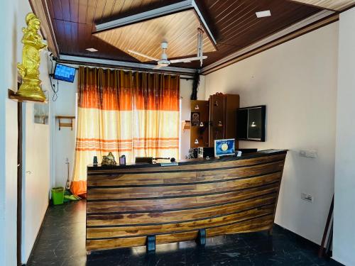a large wooden bar in a room at Esha Beach Resort Rooms in Trincomalee