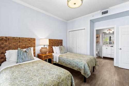 a bedroom with two beds and a lamp at Bologna Golf Condo in the Lely Resort in Naples