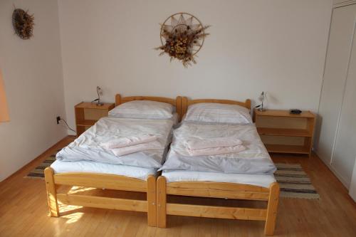 a bed with two pillows on it in a room at Penzion Mühl in Bedřichov