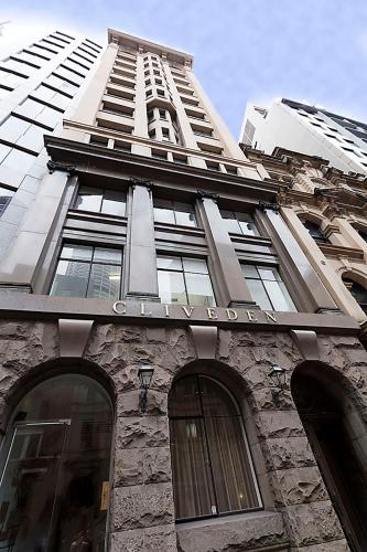 a tall building with a sign on top of it at Heart of Sydney CBD Chic One Bedroom Apartment with Pool on Bridge Street in Sydney