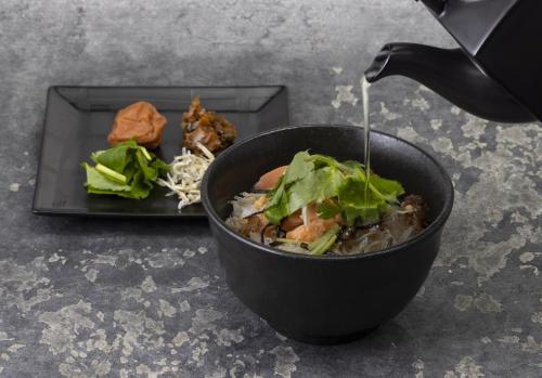 a bowl of food on a table with a plate of food at Hotel New Otani Tokyo EXECUTIVE HOUSE ZEN in Tokyo