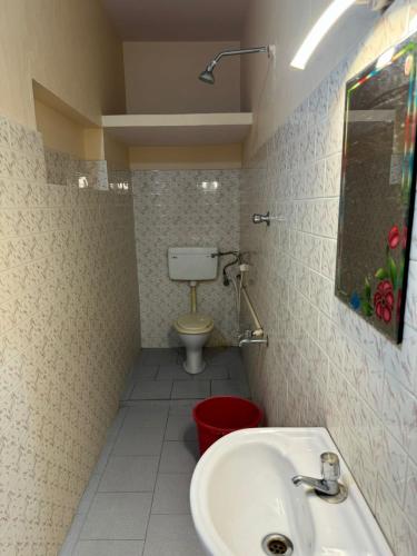 a bathroom with a sink and a toilet at Aambal Residency in Cochin