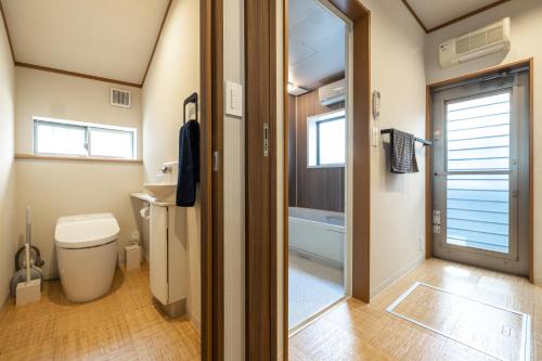 a small bathroom with a toilet and a sink at StellaStoria HAYAMA Seaside house with open-air bath in Hayama