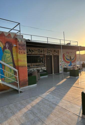 a building with a mural on the side of it at Matto Pyramids Inn in Cairo