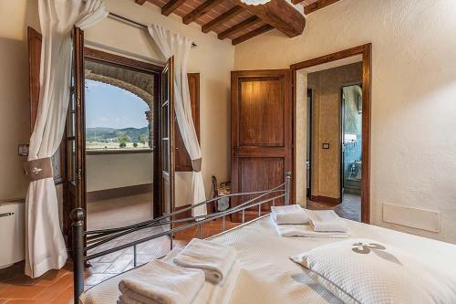 Un dormitorio con una cama y un espejo grande. en Fratta Apartments, en Cortona