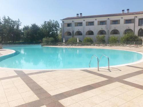 a large swimming pool in front of a building at The Flowers - Apartments with Private Garden in Residence with Pool in Manerba del Garda