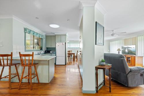 a kitchen and a living room with a table and chairs at Beach Dreams Hat Head - No Sheets or Towels provided in Hat Head