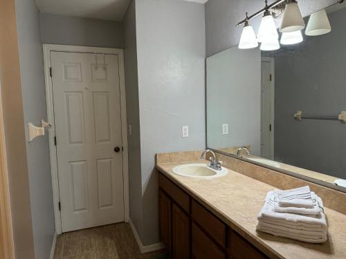 a bathroom with a sink and a mirror at A stylish and Comfy Place to Stay in Gainesville