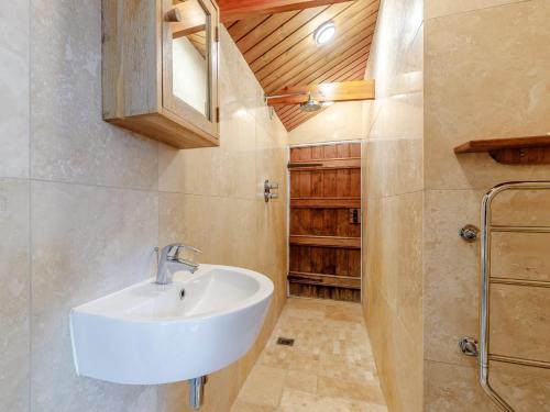 a bathroom with a sink and a wooden ceiling at 1 Bed in Wootton Under Edge EARBA in Charfield
