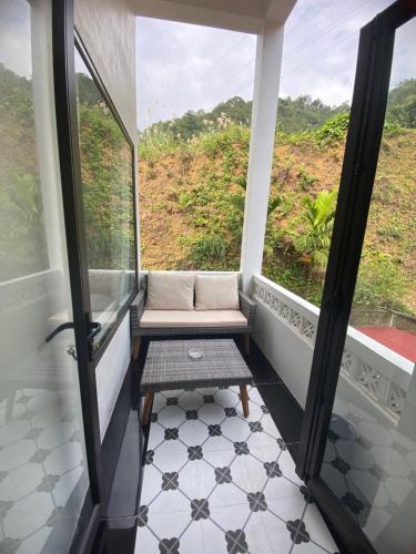 a balcony with a bench and a window at Cao Son Hotel in Bắc Quang