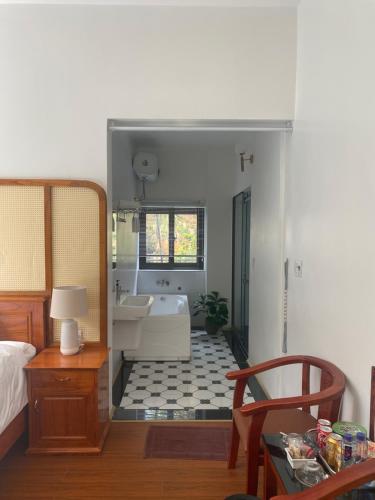 a bedroom with a bathroom with a tub and a sink at Cao Son Hotel in Bắc Quang