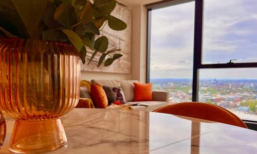 a living room with a large glass vase on a table at Highrise Best Location 2 Bedrooms & 2 Bathrooms in Melbourne
