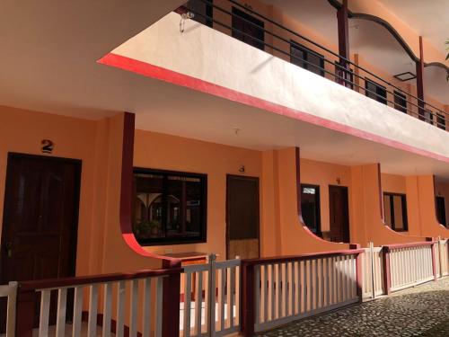 a view of the outside of a house with a balcony at JBR Tourist Inn - Port Barton in Itaytay