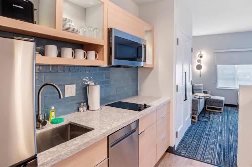 uma cozinha com um lavatório e um micro-ondas em TownePlace Suites by Marriott Richmond Colonial Heights em Colonial Heights