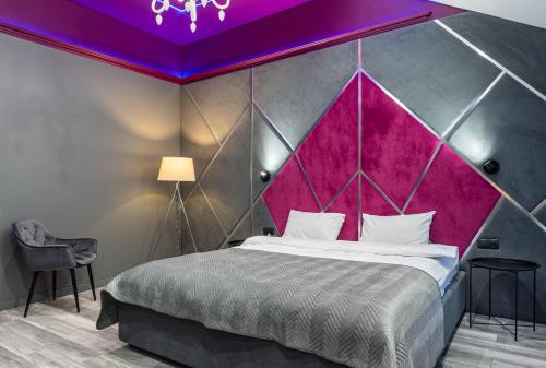 a bedroom with a large bed with a purple ceiling at LUX Апартаменти MYFREEDOM поруч метро Театральна, Хрещатик in Kyiv