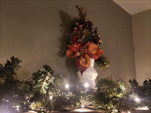 a christmas wreath on a wall with christmas trees at Wine Reflections Apartment near Nafplio in Néa Kíos