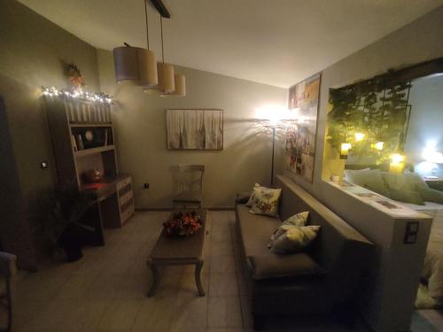 a living room with a couch and a table at Wine Reflections Apartment near Nafplio in Néa Kíos