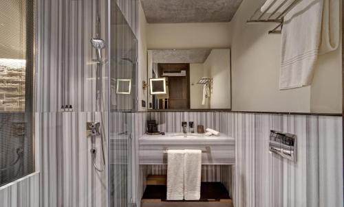 a bathroom with a sink and a shower at DeCamondo Galata, a Tribute Portfolio Hotel in Istanbul
