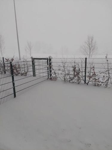 a fence with snow on the top of it at Eni-Time Mariazell mit Jakuzzi und Sauna in Mariazell