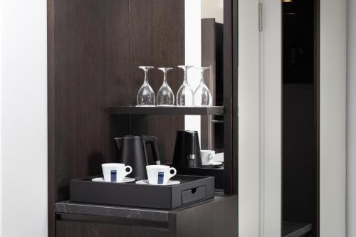 a shelf with glass vases and cups on it at Hilton Heidelberg in Heidelberg