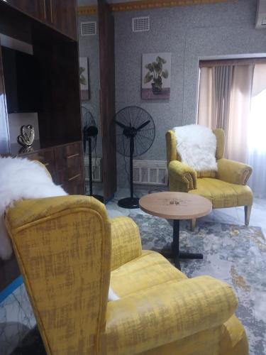 a living room with two chairs and a table at Danko baba guest house & etc. in Welkom