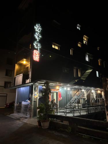 a restaurant at night with a sign on the side at 若華軒民宿Ruohuaxuan in Fangliao