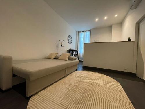 a bedroom with a large bed and a rug at Charmant Studio - Port de Nice in Nice