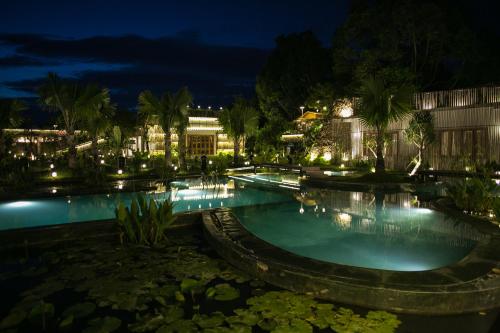 a large swimming pool at night with lights at Tổ Boutique Garden in La Gi