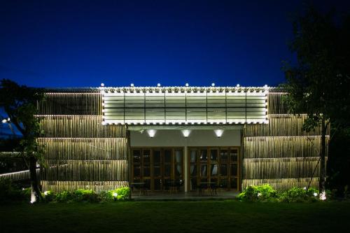 a building with a lit up facade at night at Tổ Boutique Garden in La Gi