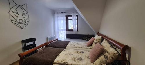 a bedroom with a bed in a room with a window at APARTAMENT 2 pokojowy in Białka Tatrzańska