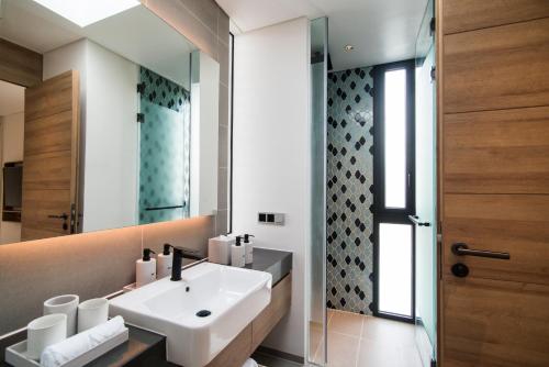 a bathroom with a sink and a mirror at Sailing Club Signature Resort Phu Quoc in Phu Quoc