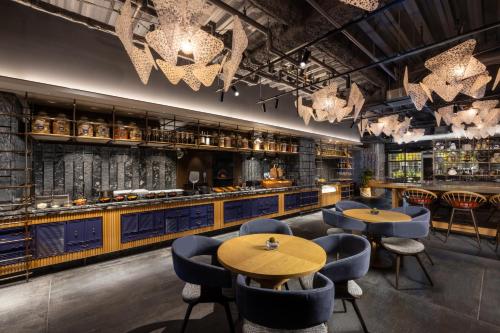 a restaurant with tables and chairs and a bar at Mercure Kyoto Station in Kyoto