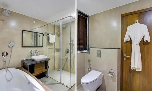 a bathroom with a toilet a sink and a shower at Okean De Goa Vagator in Vagator