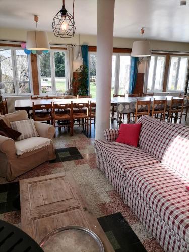 a living room with two couches and a dining room at Maison La Vigne - Gîtes et Chambres d'hôtes in Le Chambon-sur-Lignon
