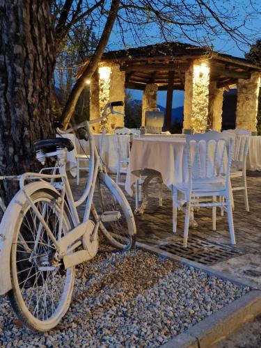 a white bike parked next to a table and chairs at Tenuta Oliva in Fisciano
