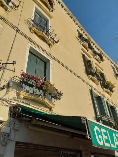 a building with a window and flower boxes on it at Cà Del Dose in Venice