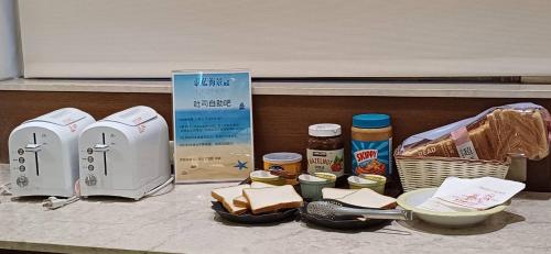 a counter with a counter top with food and a toaster at Blue Ocean Hotel in Keelung