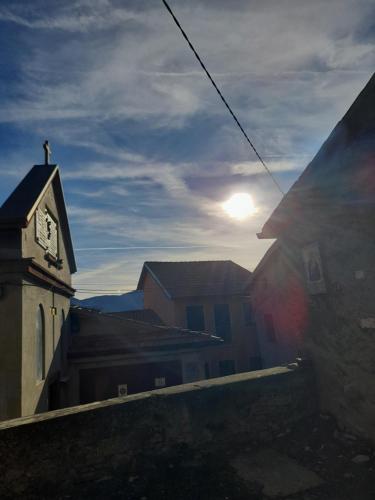 a clock tower on a building with the sun in the sky at Beb san giorgio in Volpino