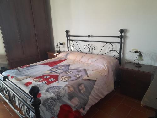 a bedroom with a bed with a black frame at Beb san giorgio in Volpino