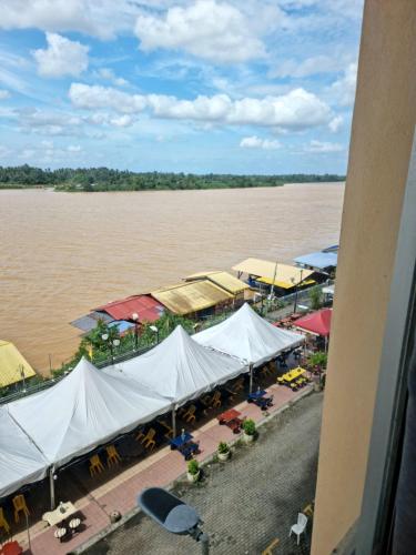 an aerial view of a market by the water at Destiny Riverside Hotel in Kota Bharu