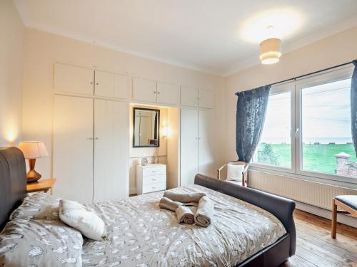 a bedroom with a bed and a large window at 3 Bed in Lowestoft 75154 in Lowestoft