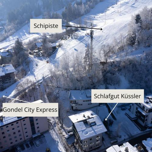 a view of a city in the snow with buildings at Schlafgut Küssler - 70m vom City Express in Zell am See